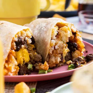 Hash-a-Burrito! 
Smoked ham, Scrambled eggs, Mama's potatoes, grilled onions, cheddar and mozzarella,
wrapped in a tortilla, salsa