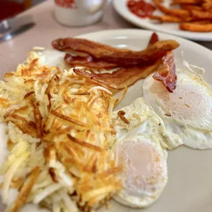 Fried eggs, hashbrowns, bacon