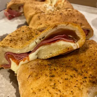 Stromboli-signature pizza dough &amp; baked in our Old World Brick Ovens, filled with salami, ham, pepperoni, mozzarella &amp; provolone