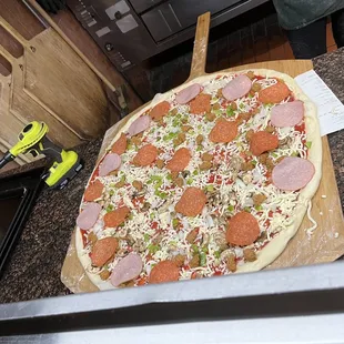 Before the oven. Pepp, cheese, shrooms, green peppers, sausage and onions.