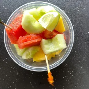 a bowl of fruit on a stick