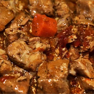 a close up of a stew with meat and carrots