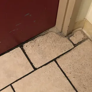 a tile floor and a red door