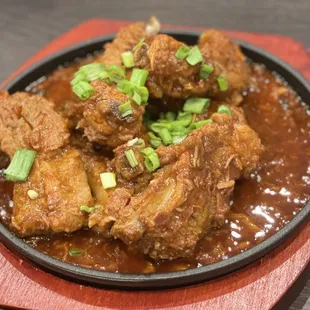 Pork ribs - full of flavors and super tender!  You can mix the sauce with the rice!  You can ask for mild or spicy.