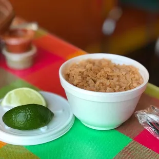a bowl of rice and a lime