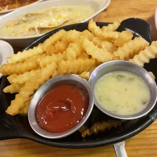 French fries with ketchup and green chili sauce