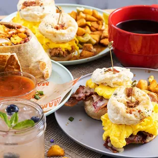 Drew's Biscuit Sliders with 2 bacon biscuits, thick sliced bacon, scrambled eggs, cheddar, potatoes, 
country gravy