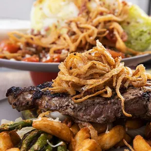 Enjoy a hand-cut New York Steak with a crisp, wedge salad topped with blue cheese crumbles, cherry tomato and thick bacon chunks.