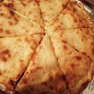 a cheese pizza cut into eight slices