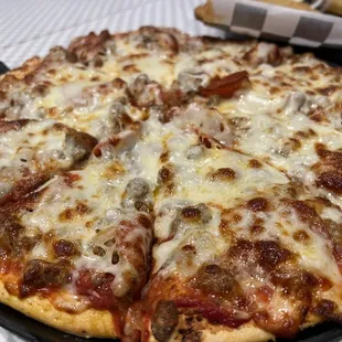 a pizza with sausage and cheese