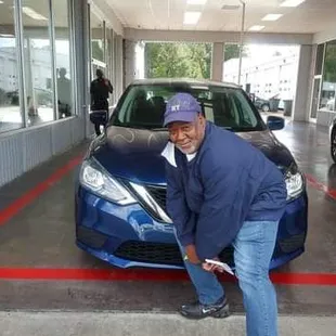 a man leaning over a car