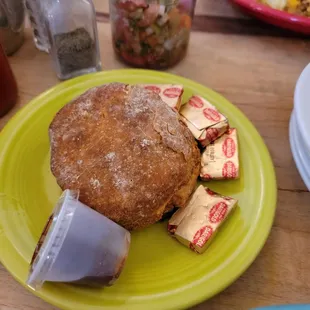 a muffin on a green plate