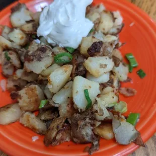 Home fries on side with sour cream