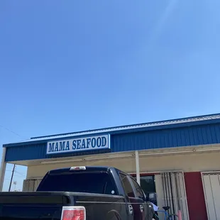 a truck parked in front of a restaurant