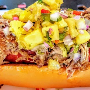 This hot dog doesn't get more islander than this Kalua dog topped with pineapple salsa.