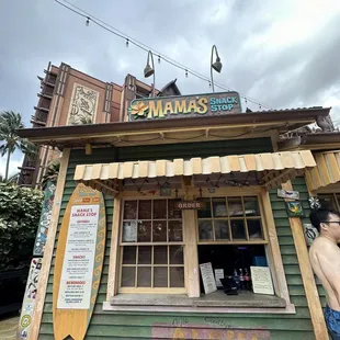 a man standing in front of a restaurant