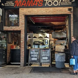a woman standing in front of a restaurant
