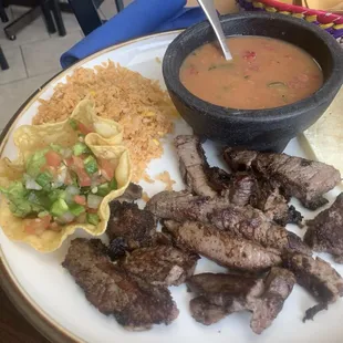 Fajita plate with rice and ranchero beans guacamole with pico de gallo
