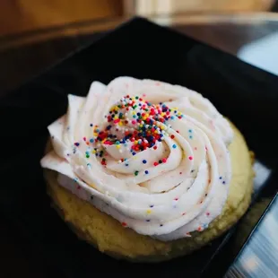 a cupcake with frosting and sprinkles