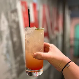 a hand holding a drink