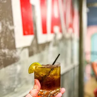 a hand holding a drink