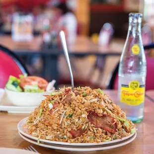a plate of fried rice and a bottle of water