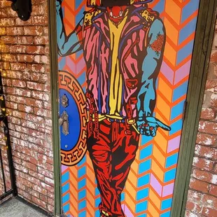 a door painted with a colorful image of a man