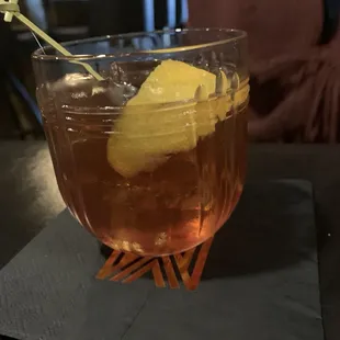 a drink in a glass with a lemon wedge