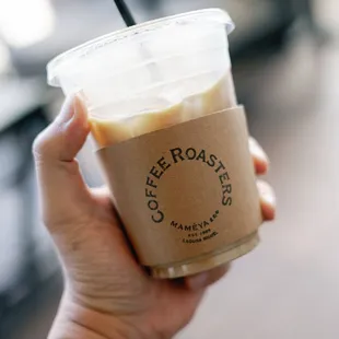 a hand holding a cup of coffee