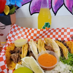 a plate of tacos and a drink