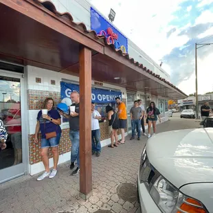 a group of people standing outside of a store