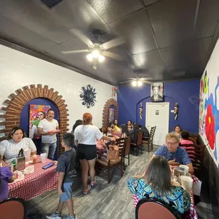 a group of people sitting at tables in a restaurant