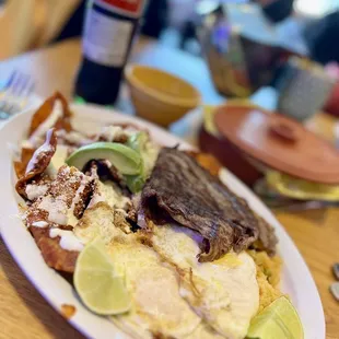 Chilaquiles rojo con huevo, rice, chips &amp; beans *agregue cecina.  (Cecina is salt cured beef)