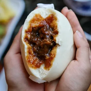 a person holding a bun