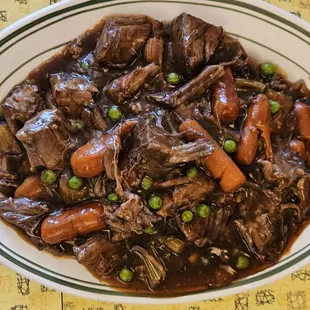 Beef Pot Roast with peas, carrots, and mashed potatoes underneath!
