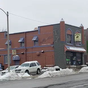 a brick building with a clock on the front