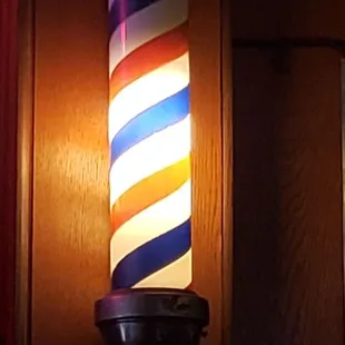 a barber pole with a flag on it