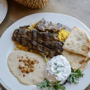 Beef angus kabob Plate served with our hummus cucumber yogurt rice pilaf and pita bread.