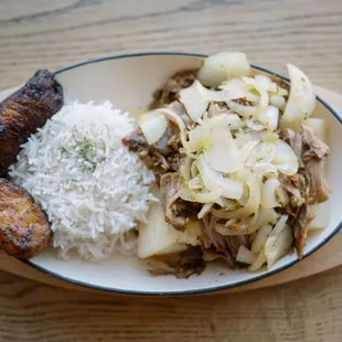 Over roasted Lechon Asado simmered in a tangy garlic marinade!