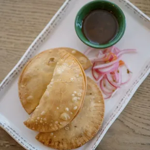 All great things come in 3!! Beef empanadas served with our signature chimmichuri empanadas and our habanero pickle!