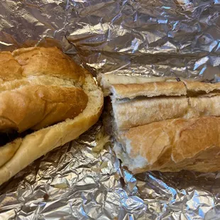 a half eaten sandwich on tin foil