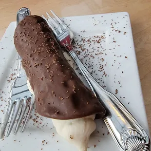a chocolate ice cream roll on a plate
