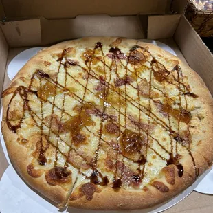 Asiago Specialty pizza: Mozzarella cheese, smoked bacon, Asiago cheese, fig preserve, grated Romano cheese topped with balsamic glaze.