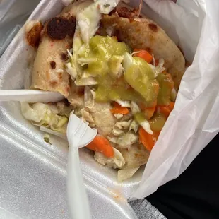 a person holding a fork and a plastic container