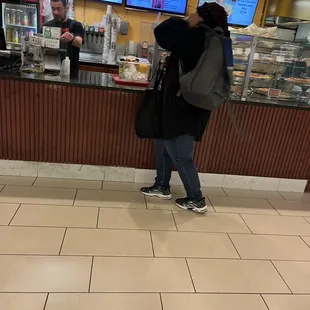 two people standing at a counter