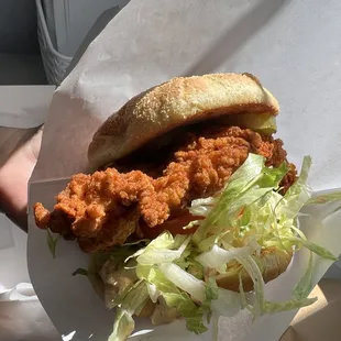 a hand holding a sandwich