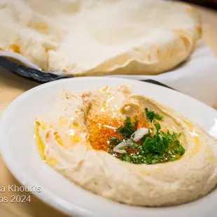 Hummus 
 A Thick Creamy Garbanzo Bean Dip Made with, Tahini, Lemon Juice, and Garlic. VGN