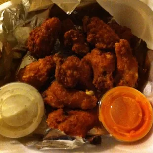 Perfectly crispy wings with ranch and hot sauce on the side