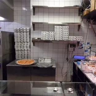 a kitchen with a pizza on the counter