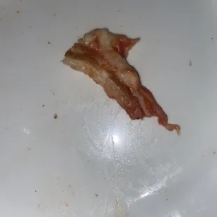 a piece of bacon on a plate